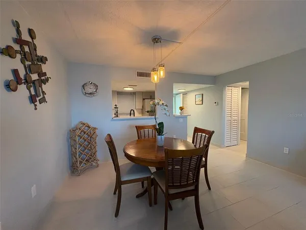 a view of a dining room with furniture and chandelier