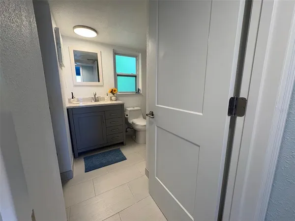 a bathroom with a toilet sink and mirror