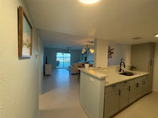 a kitchen with a refrigerator and a sink
