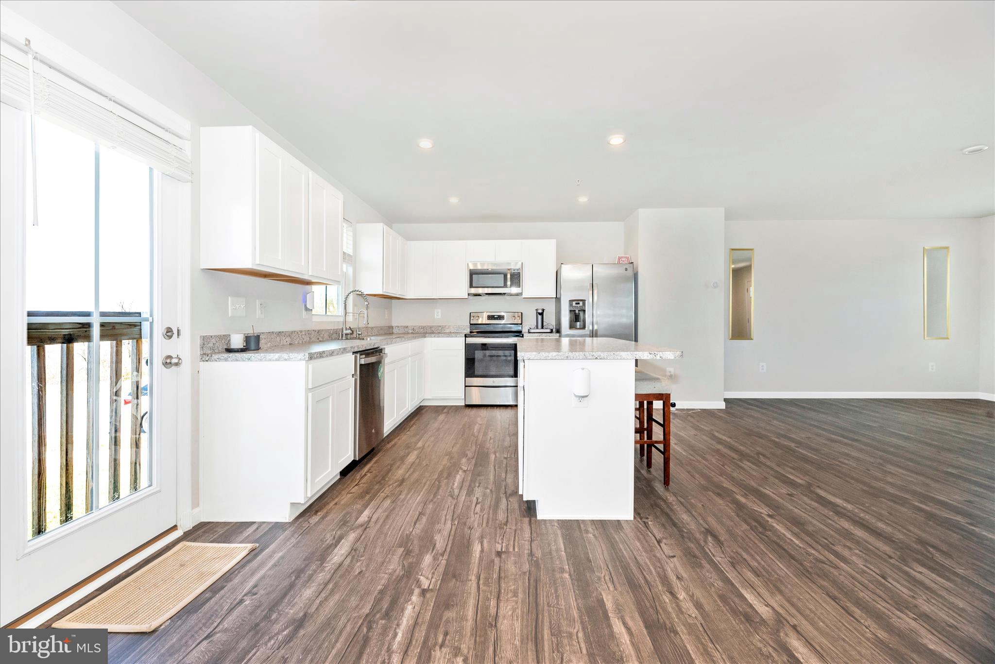 336 Burnside Avenue Taneytown, MD 21787 - Photo 14 of 53 a kitchen with wooden floors and white appliances