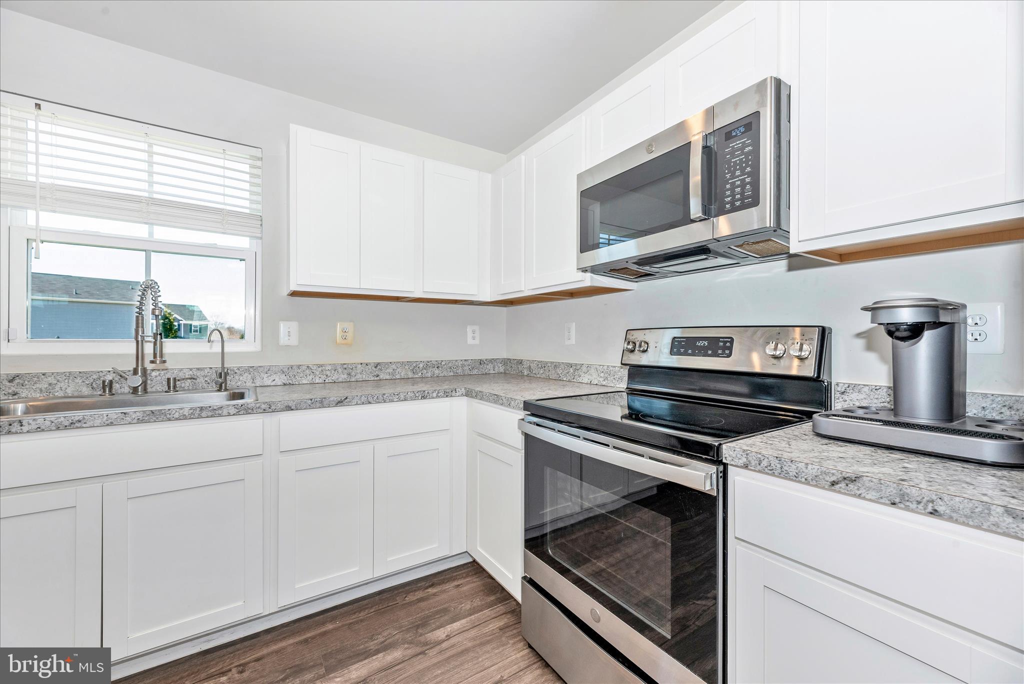 336 Burnside Avenue Taneytown, MD 21787 - Photo 18 of 53 a kitchen with granite countertop a stove microwave and sink