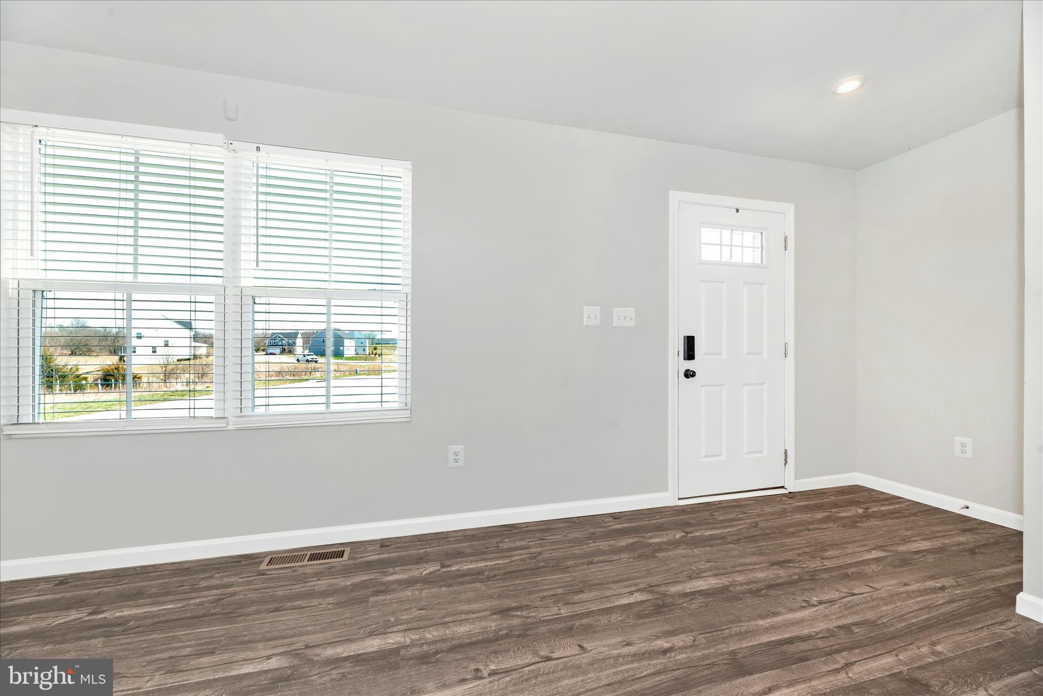 336 Burnside Avenue Taneytown, MD 21787 - Photo 21 of 53 a view of an empty room with wooden floor and a window