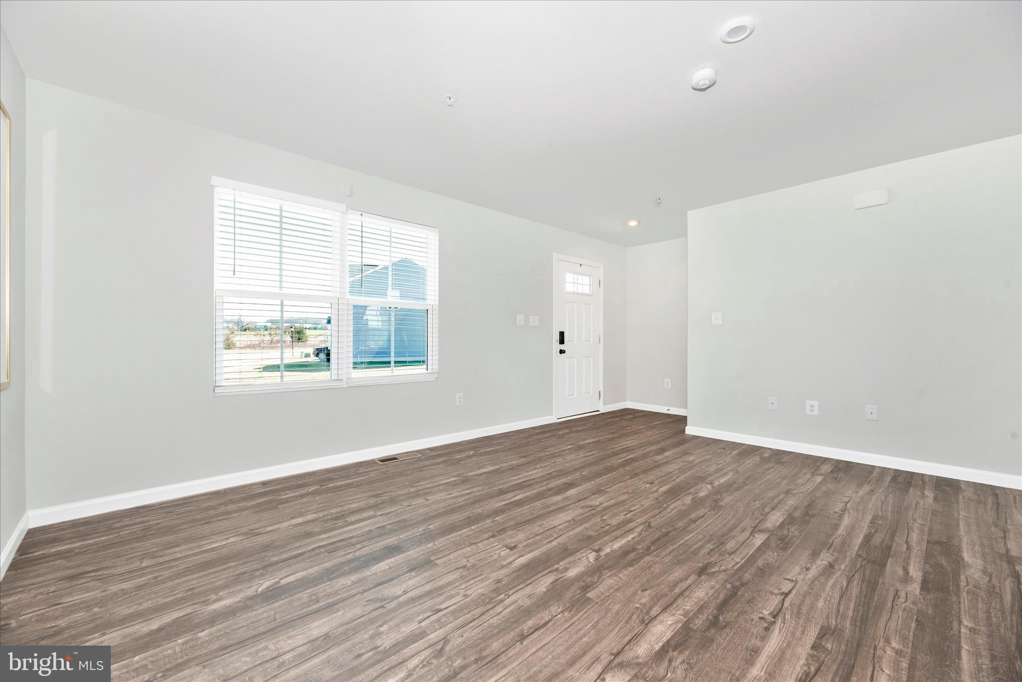336 Burnside Avenue Taneytown, MD 21787 - Photo 23 of 53 an empty room with wooden floor and windows