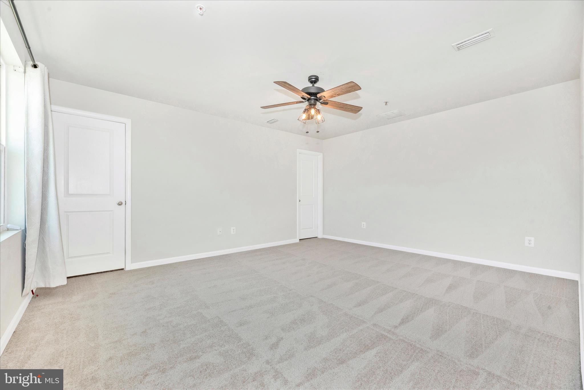 336 Burnside Avenue Taneytown, MD 21787 - Photo 28 of 53 an empty room with a chandelier fan and windows