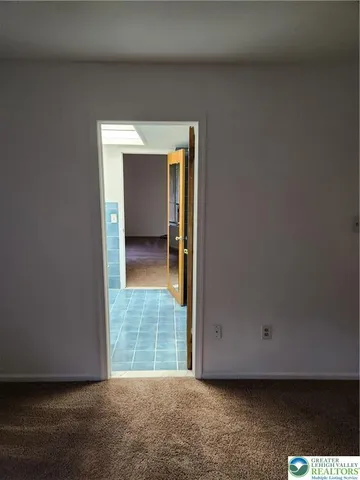 a view of an empty room with a fireplace
