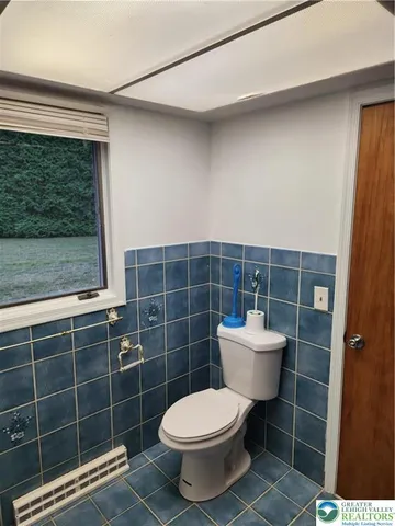 a bathroom with a toilet a sink and a mirror