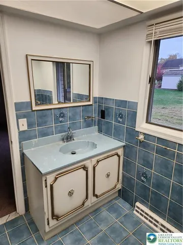 a utility room with a sink and a mirror
