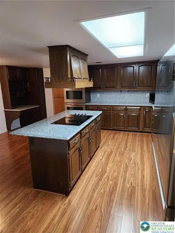 a kitchen with stainless steel appliances granite countertop a stove and a sink