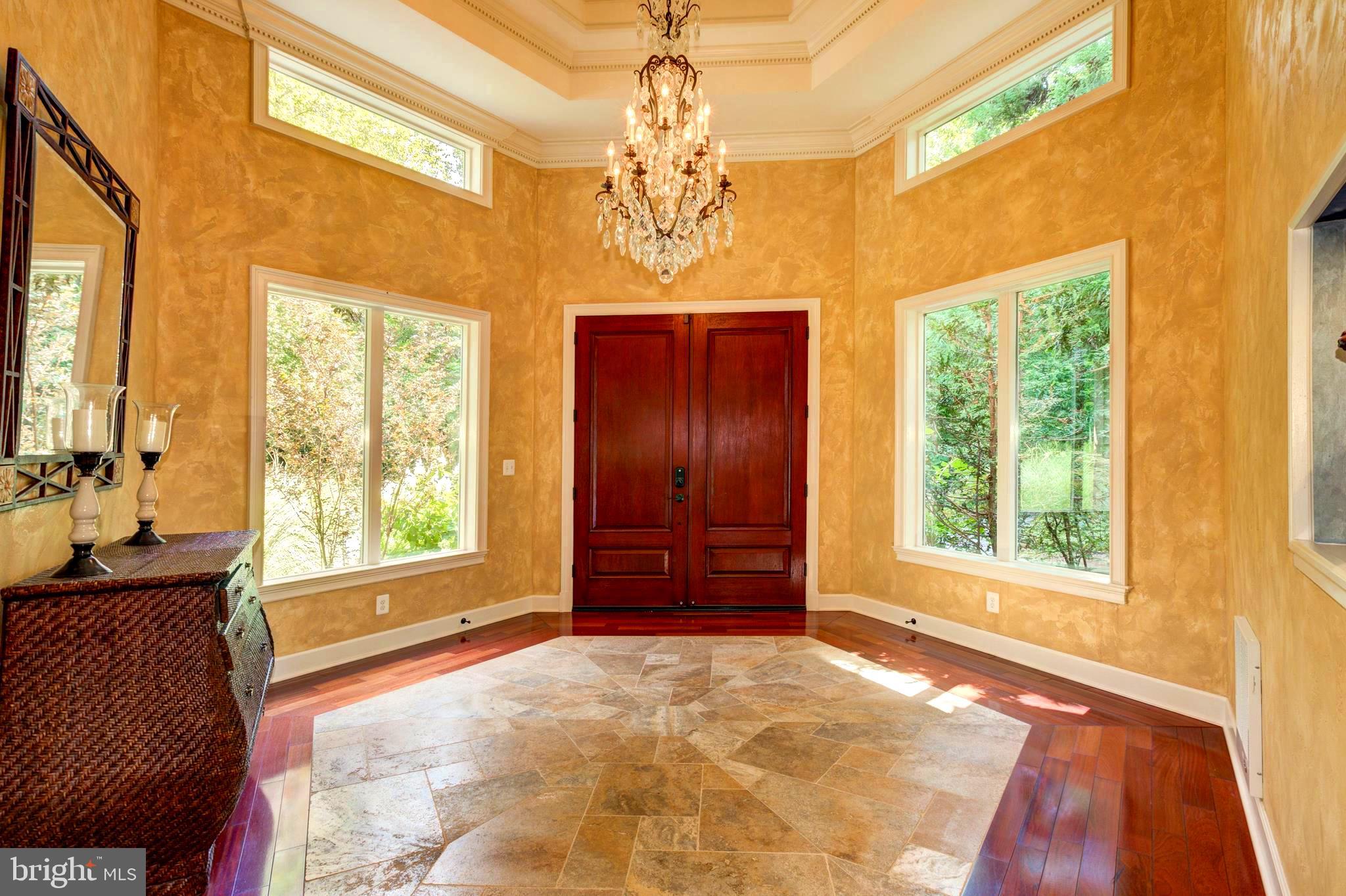 724 Clear Spring Road Great Falls, VA 22066 - Photo 7 of 57 The foyer tile and wood floors and tray ceiling