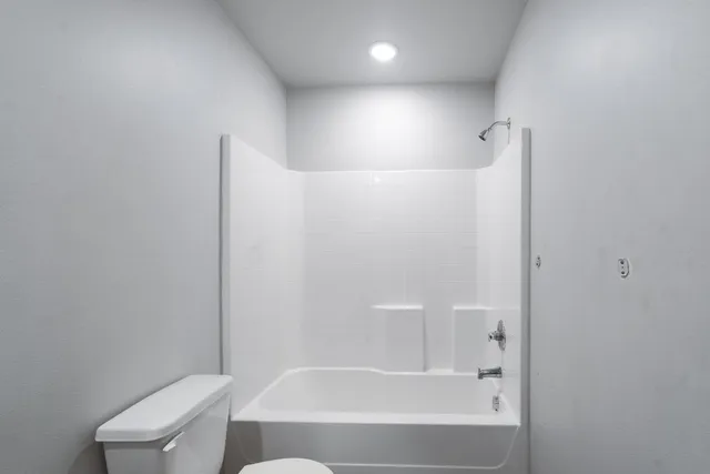 a bathroom with a bathtub and a toilet