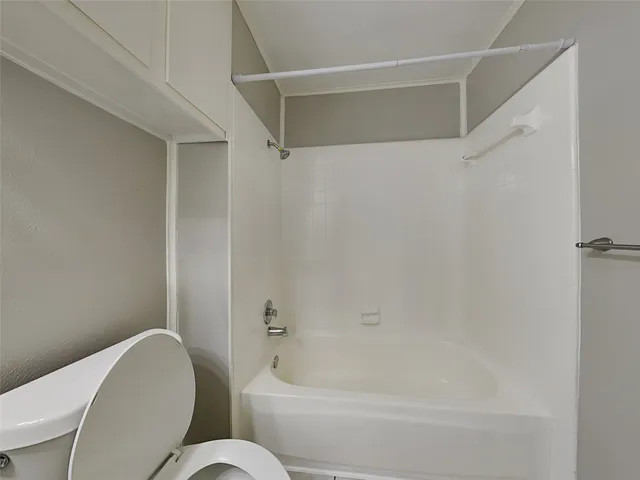 a bathroom with a toilet and a bathtub