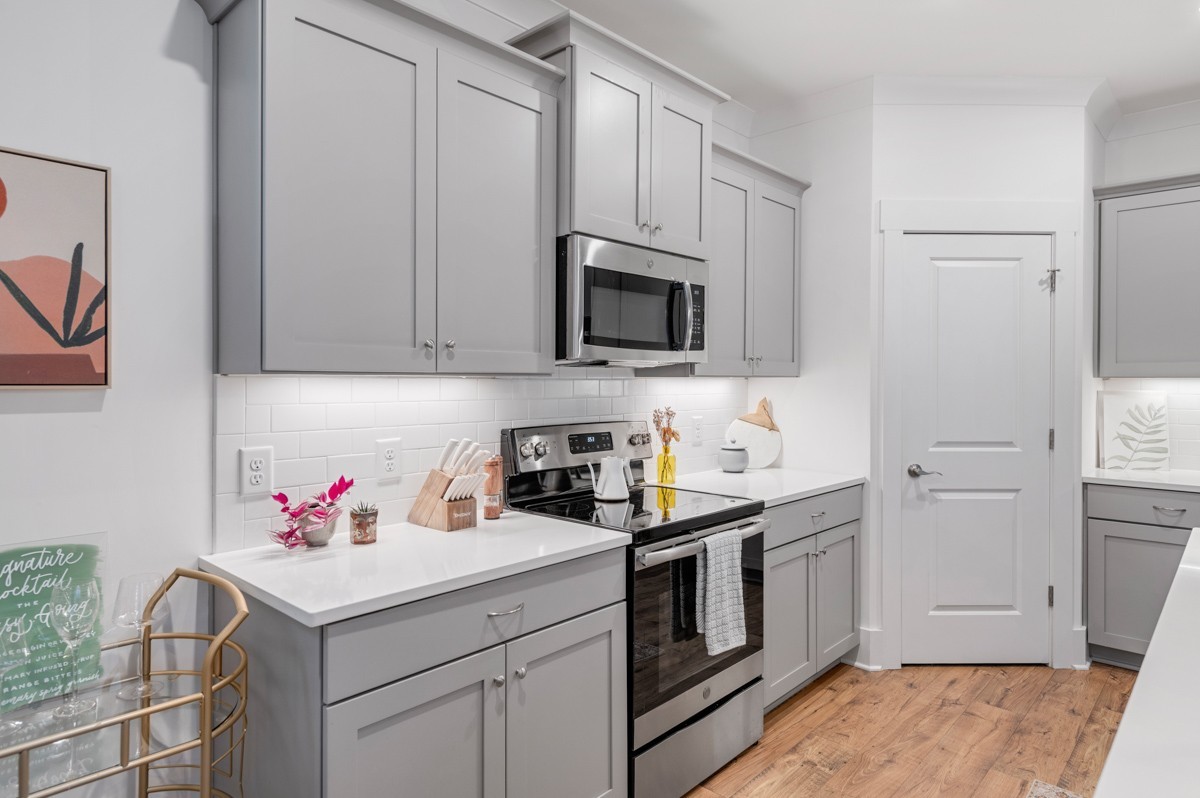 6043 Gracious Drive Franklin, TN 37064 - Photo 17 of 49 a kitchen with stainless steel appliances white cabinets and sink
