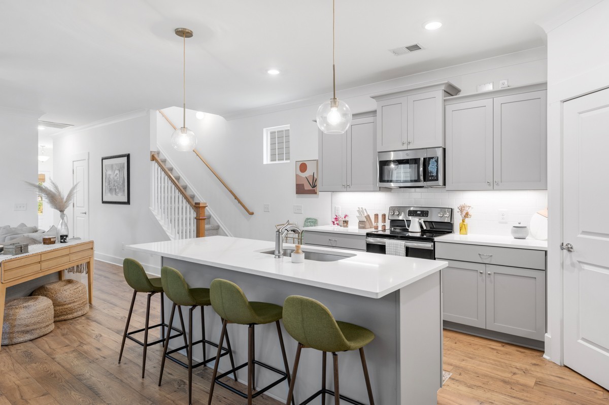 6043 Gracious Drive Franklin, TN 37064 - Photo 19 of 49 a kitchen with stainless steel appliances kitchen island granite countertop a sink a stove a dining table and chairs