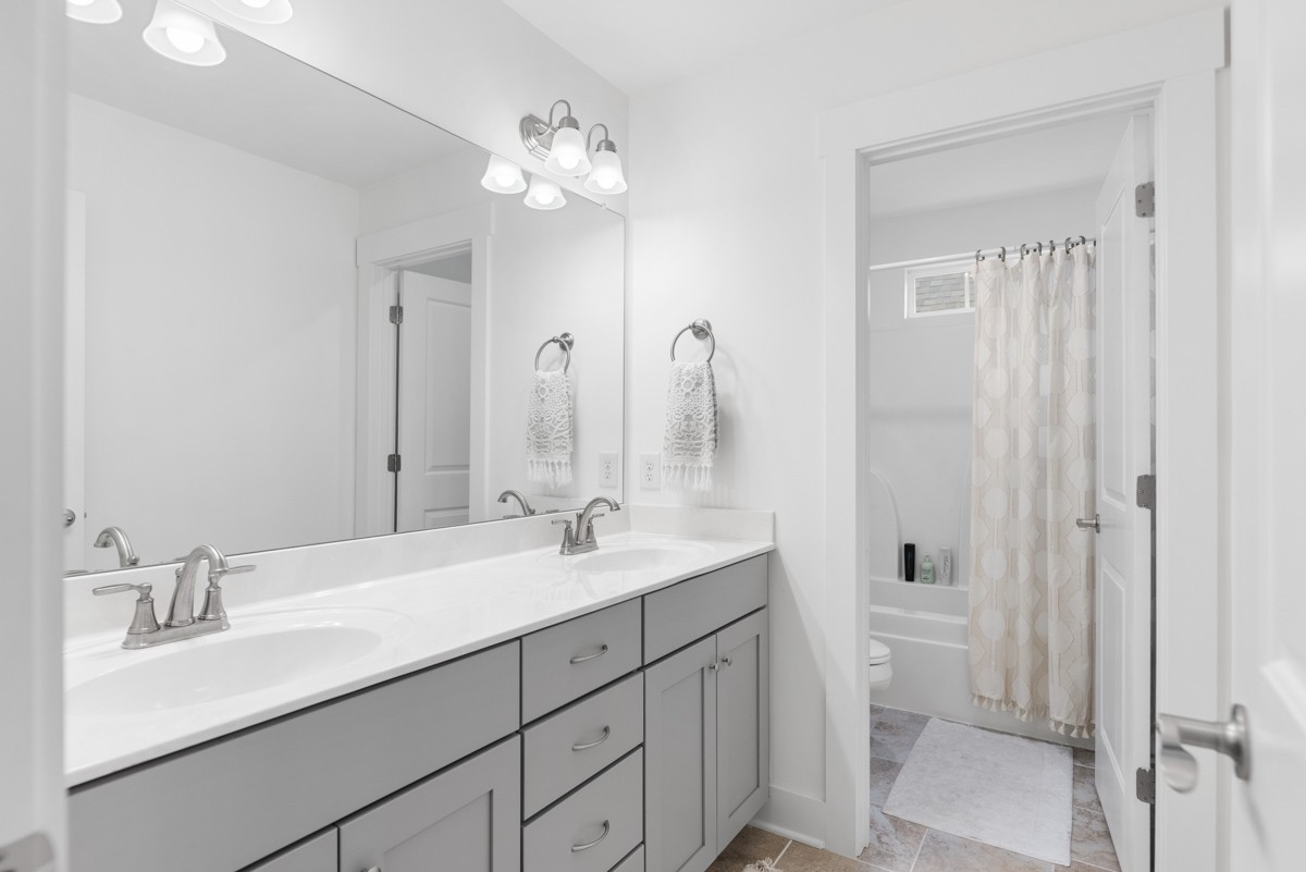 6043 Gracious Drive Franklin, TN 37064 - Photo 30 of 49 a bathroom with a sink a toilet and a large mirror