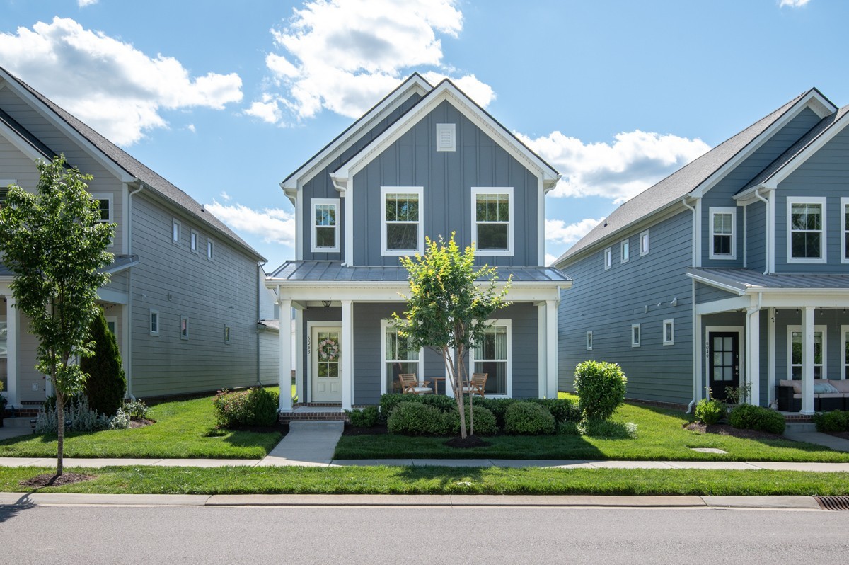6043 Gracious Drive Franklin, TN 37064 - Photo 3 of 49 a front view of a house with a yard and potted plants