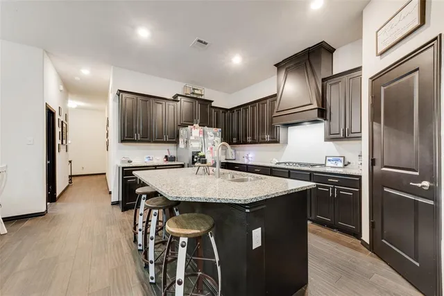 a kitchen with kitchen island a sink stove and refrigerator