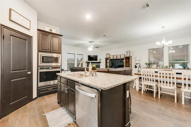 a large kitchen with a table and chairs