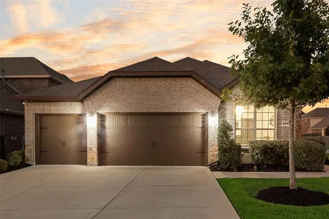 a front view of a house with yard and garage