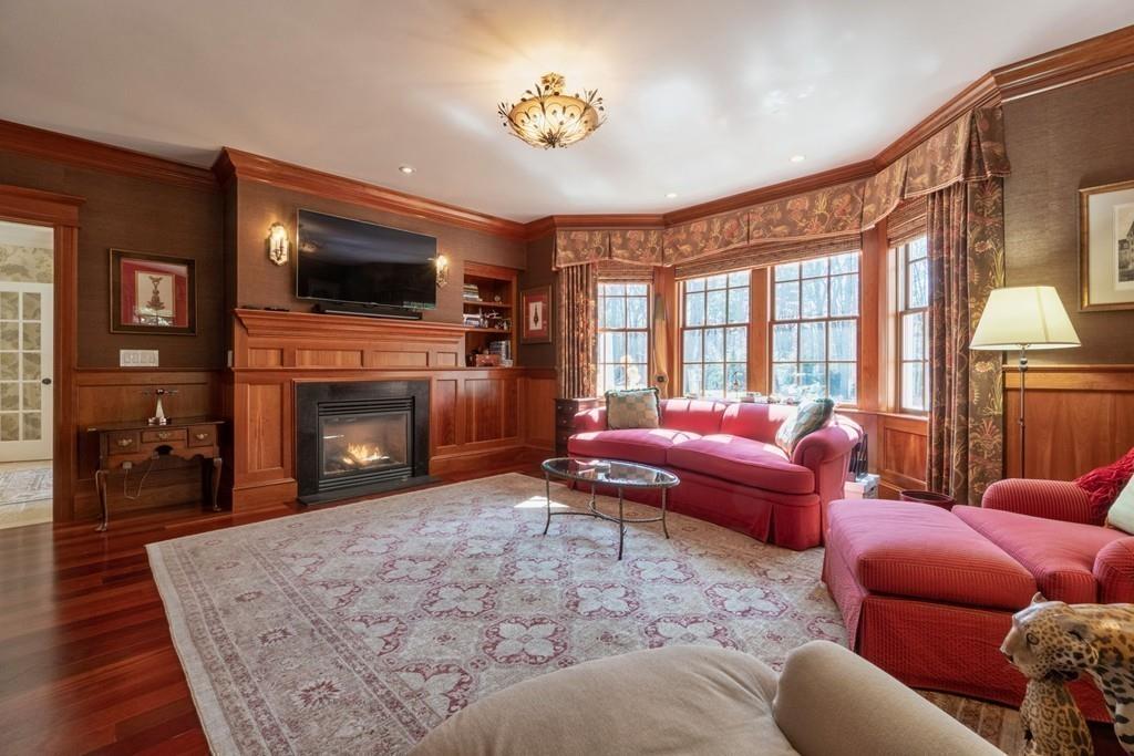 291 Musterfield Road Concord, MA 01742 - Photo 12 of 32 a living room with furniture a flat screen tv and a fireplace