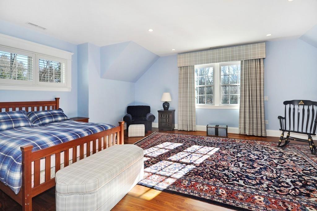 291 Musterfield Road Concord, MA 01742 - Photo 21 of 32 a bedroom with a bed a table and chair