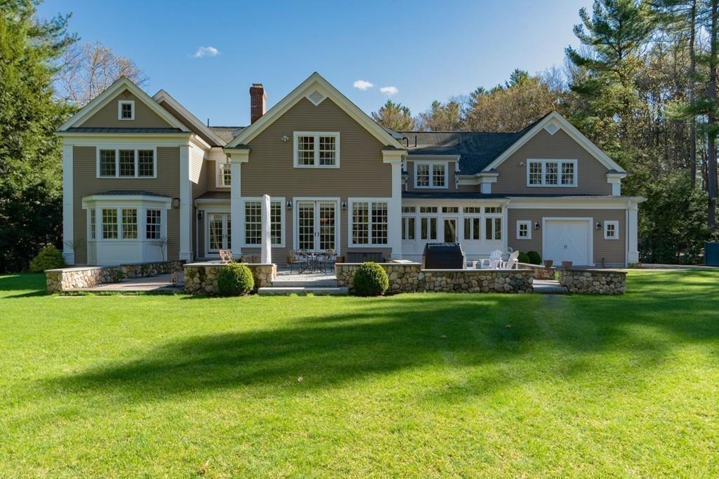 291 Musterfield Road Concord, MA 01742 - Photo 28 of 32 a front view of a house with a yard table and chairs