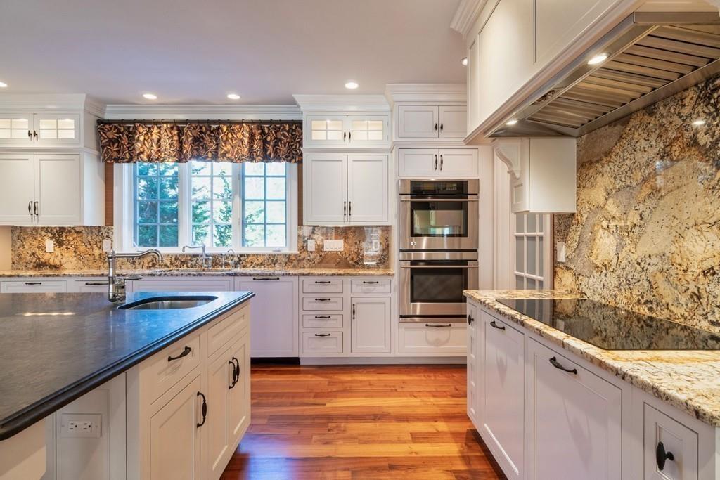 291 Musterfield Road Concord, MA 01742 - Photo 10 of 32 a kitchen with stainless steel appliances granite countertop a stove a sink and a refrigerator