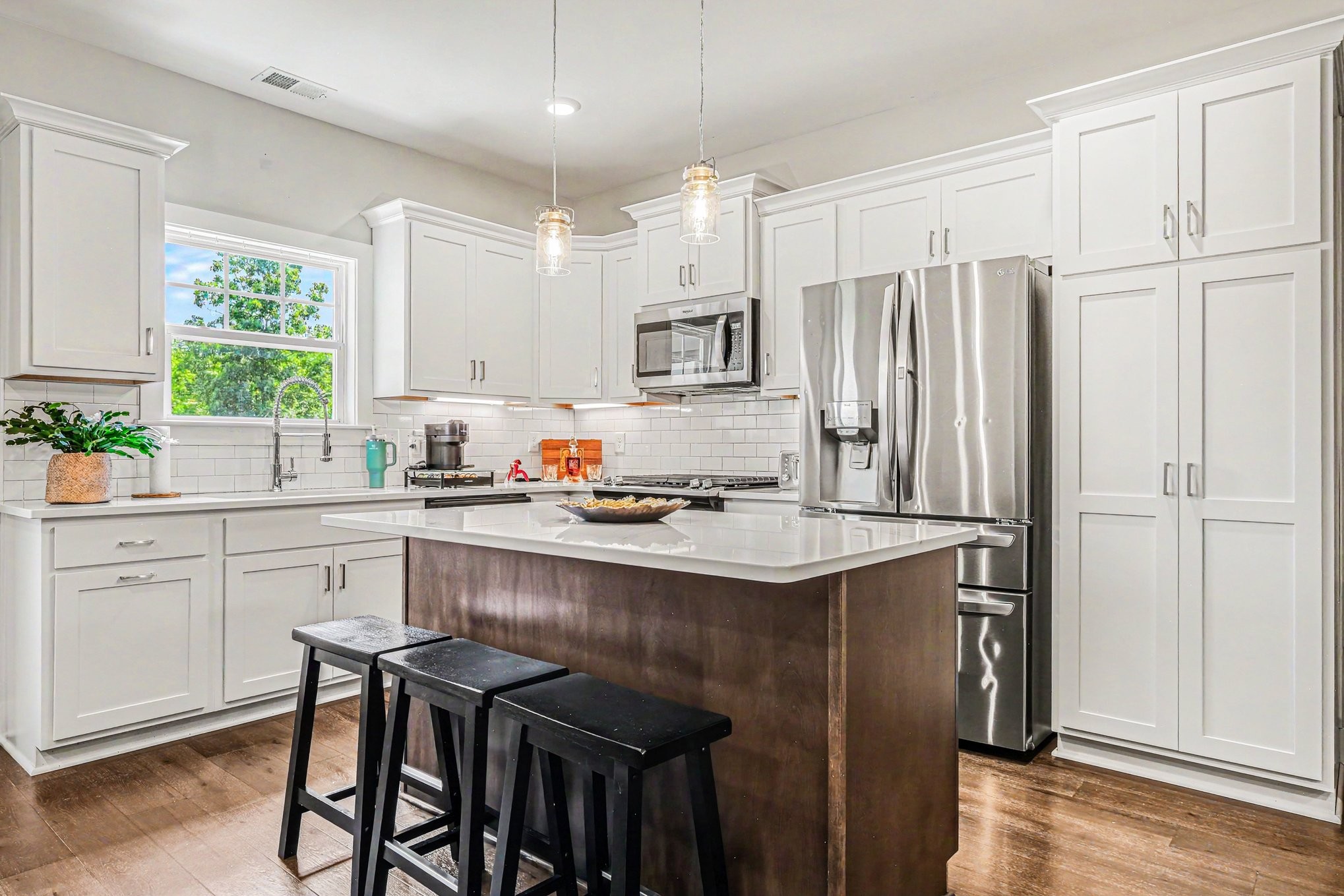 1144 Lock 4 Road, Unit H3 Gallatin, TN 37066 - Photo 6 of 22 a kitchen with stainless steel appliances granite countertop a table chairs sink refrigerator and cabinets