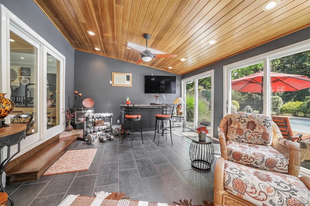 19 Mary Ellen Drive Edison, NJ 08820 - Photo 18 of 36 a living room with furniture a flat screen tv and floor to ceiling window