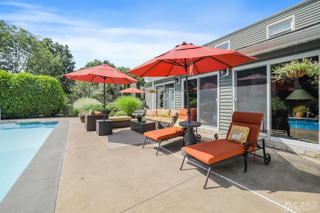 19 Mary Ellen Drive Edison, NJ 08820 - Photo 24 of 36 a patio with patio a table and chairs under an umbrella