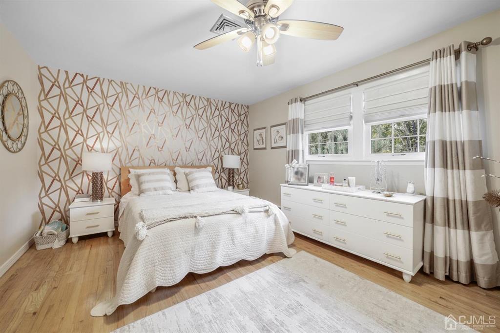 19 Mary Ellen Drive Edison, NJ 08820 - Photo 26 of 36 a bedroom with a large bed and a chandelier