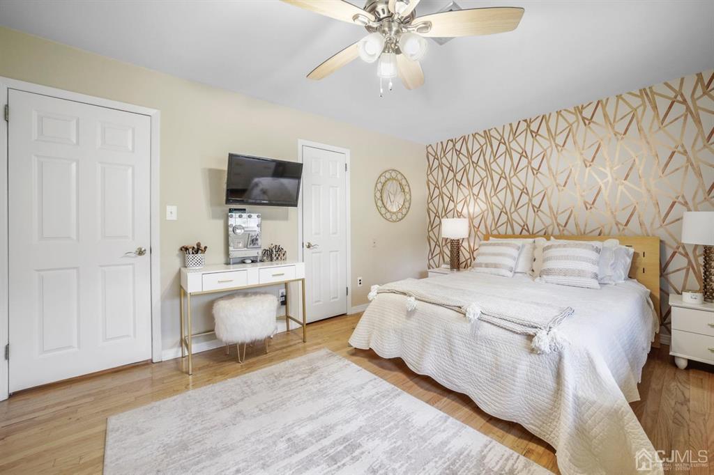 19 Mary Ellen Drive Edison, NJ 08820 - Photo 27 of 36 a spacious bedroom with a bed and a chandelier