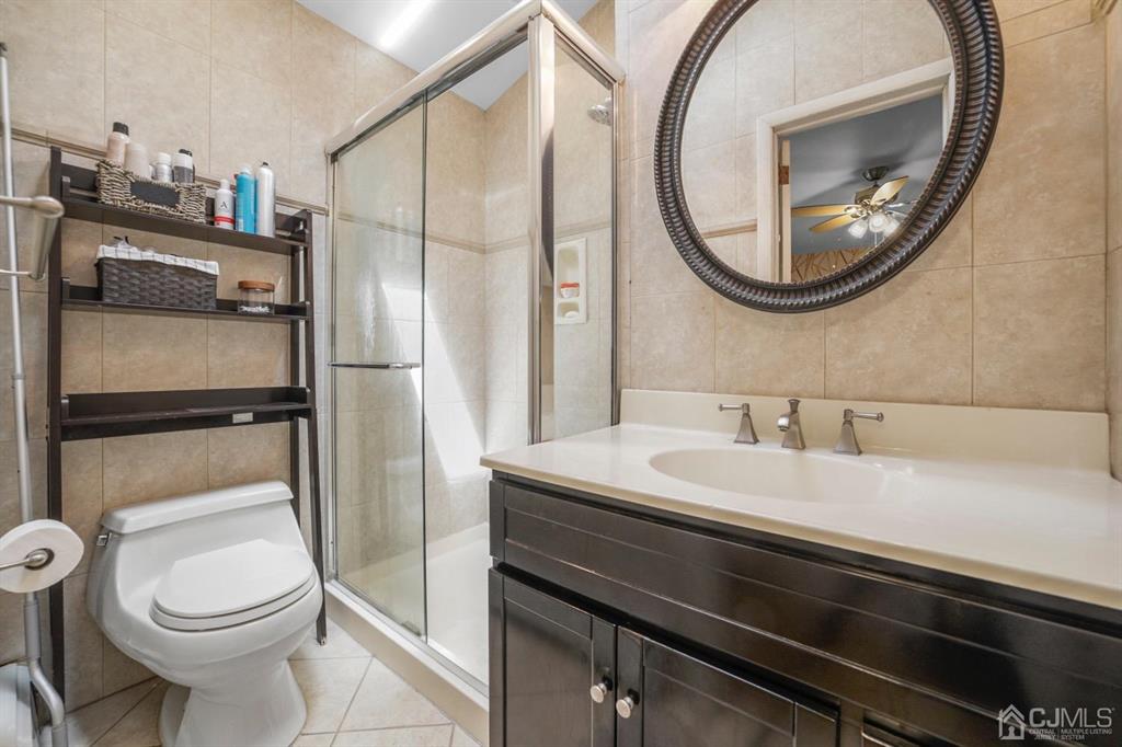 19 Mary Ellen Drive Edison, NJ 08820 - Photo 28 of 36 a bathroom with a sink a toilet and a mirror