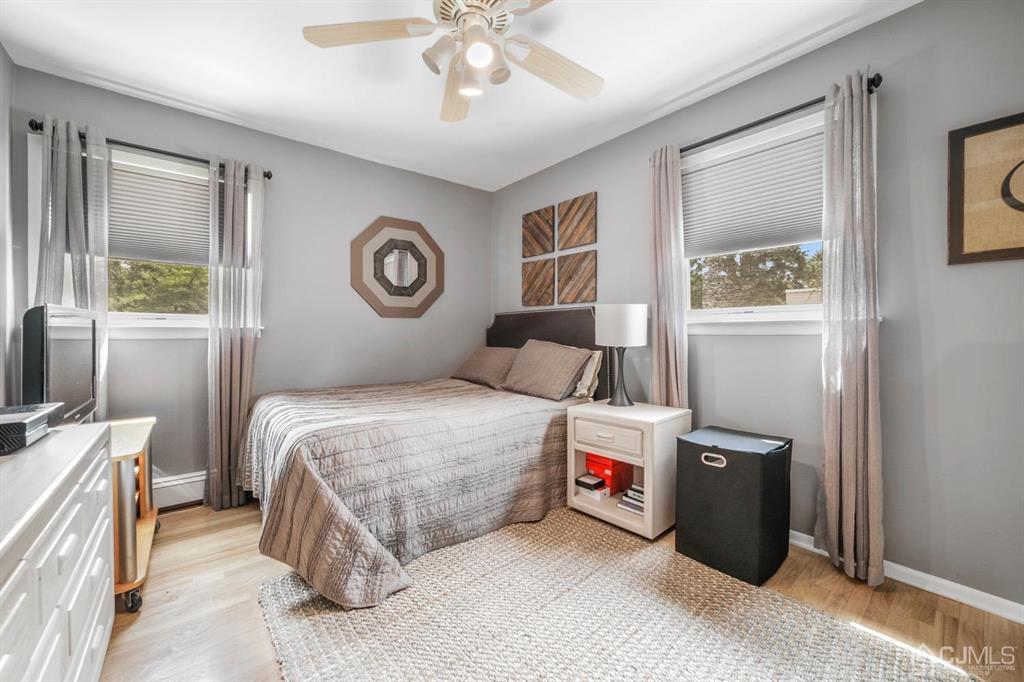 19 Mary Ellen Drive Edison, NJ 08820 - Photo 29 of 36 a bedroom with a bed and a chandelier