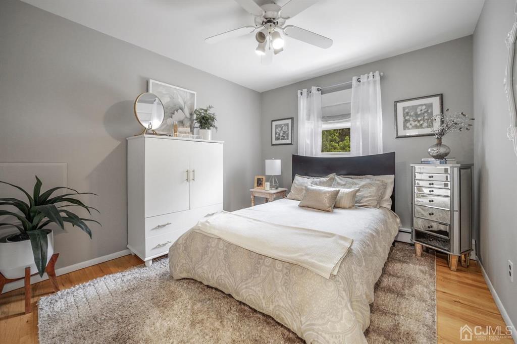 19 Mary Ellen Drive Edison, NJ 08820 - Photo 31 of 36 a bedroom with a large bed and a chandelier