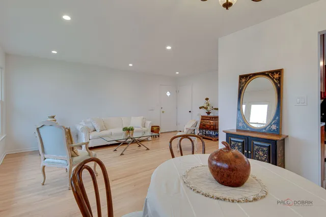a dining room with furniture and a chandelier