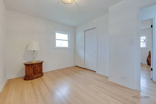 a view of an empty room and wooden floor