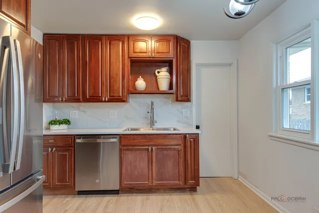 a kitchen with stainless steel appliances granite countertop wooden cabinets a sink and dishwasher