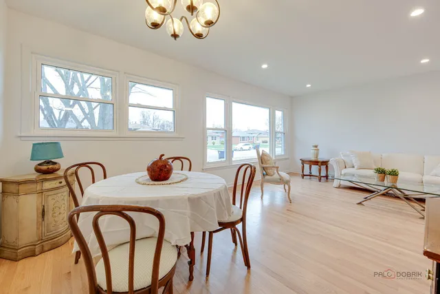 a dining room with furniture a window and wooden floor
