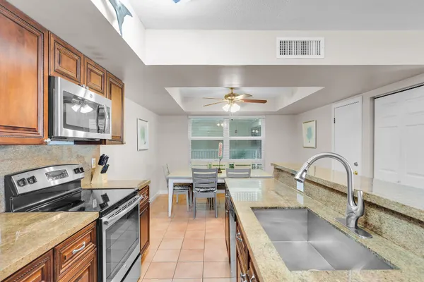 a kitchen with granite countertop a stove and a sink