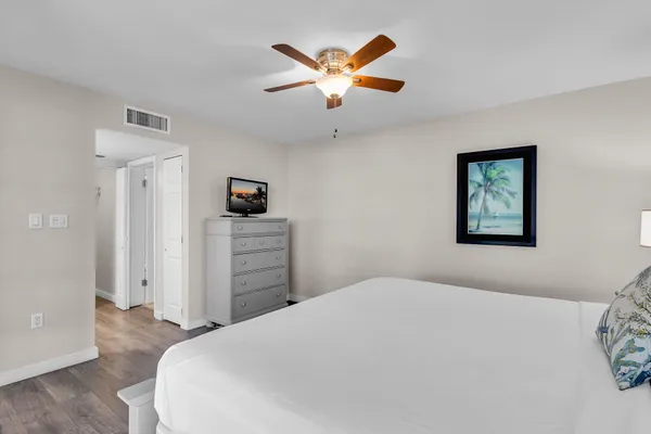 a bedroom with a bed and a ceiling fan