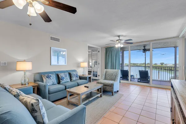 a living room with furniture and a view of kitchen