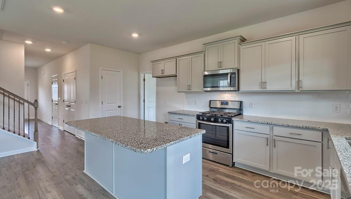 49 Shorthorn Road Fletcher, NC 28732 - Photo 3 of 19 a kitchen with stainless steel appliances granite countertop a stove a sink and a microwave