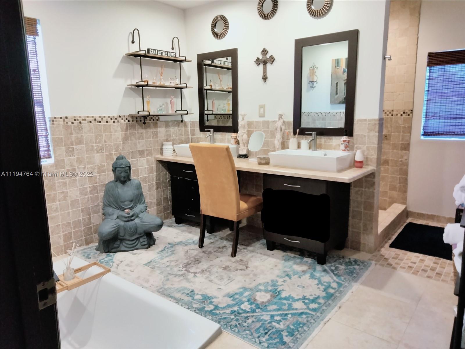 8251 Southwest 34th Terrace Miami, FL 33155 - Photo 14 of 24 a view of a bathroom with a sink and a mirror