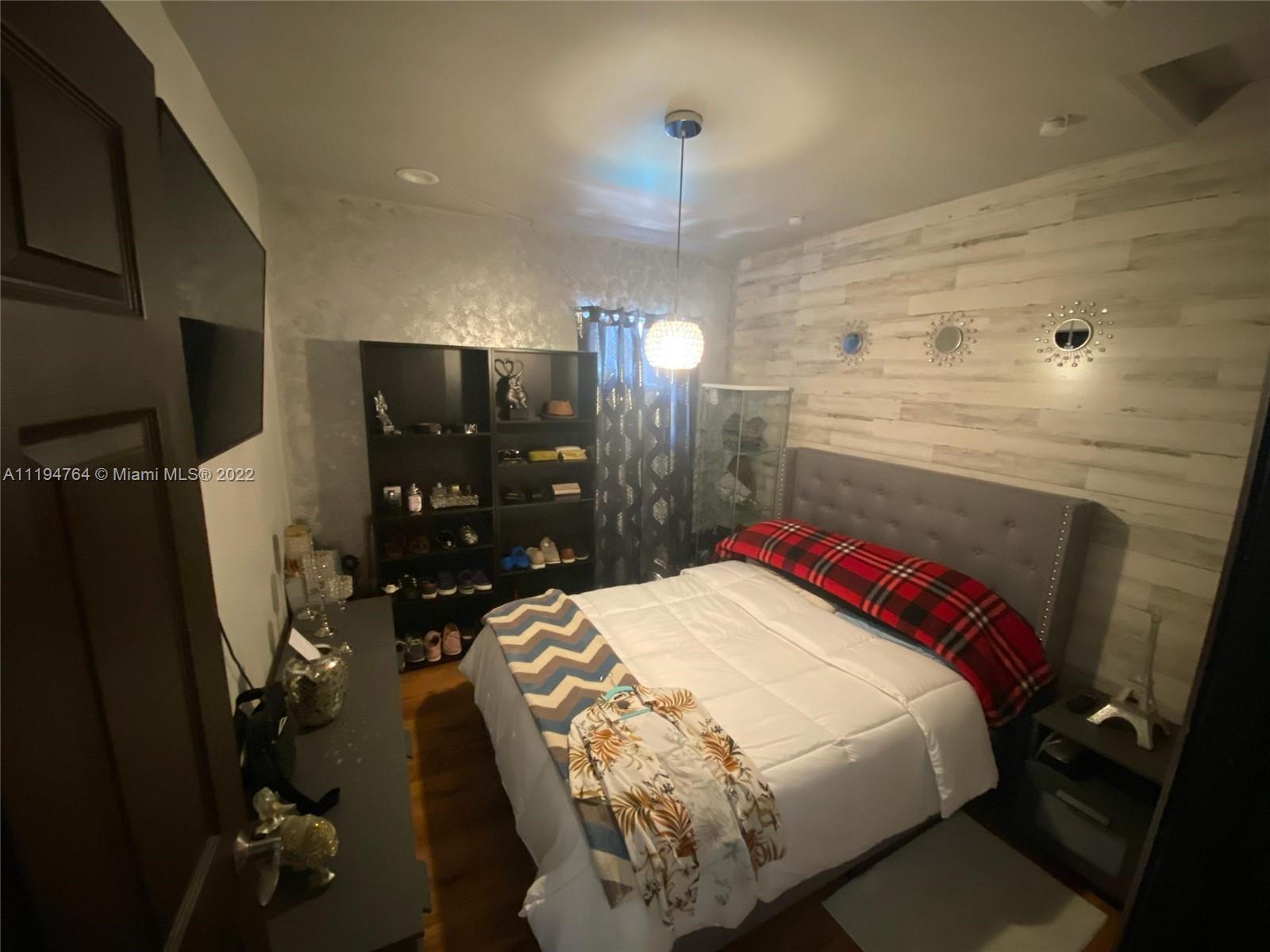 8251 Southwest 34th Terrace Miami, FL 33155 - Photo 15 of 24 a bed room with a bed and a television