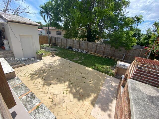 8251 Southwest 34th Terrace Miami, FL 33155 - Photo 18 of 24 a view of a backyard with wooden fence