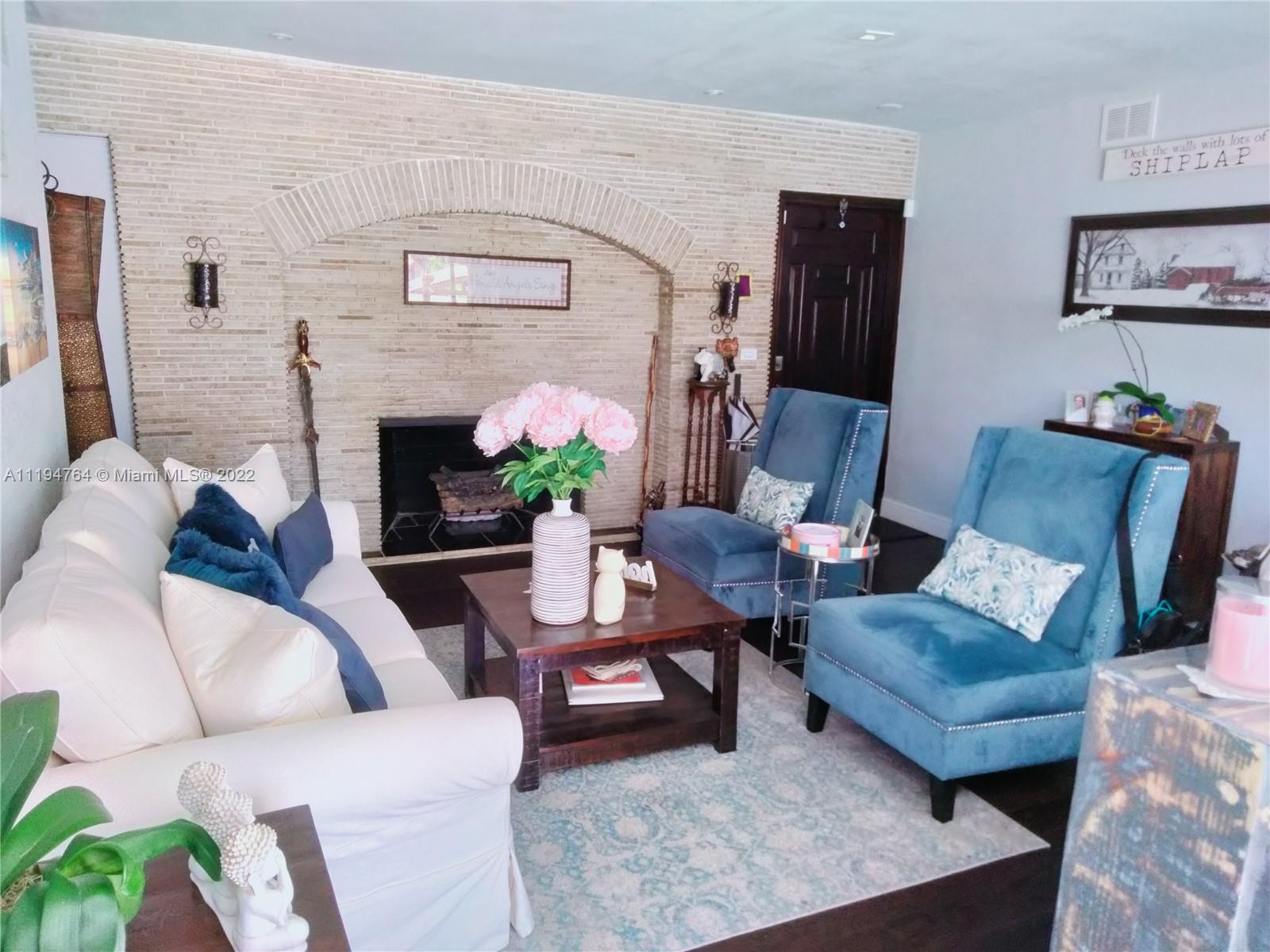 8251 Southwest 34th Terrace Miami, FL 33155 - Photo 6 of 24 a living room with furniture and a fireplace