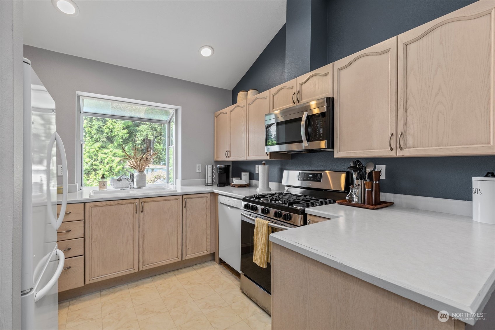 22727 4th Avenue West, Unit 106 Bothell, WA 98021 - Photo 12 of 35 a kitchen with stainless steel appliances granite countertop white cabinets and window