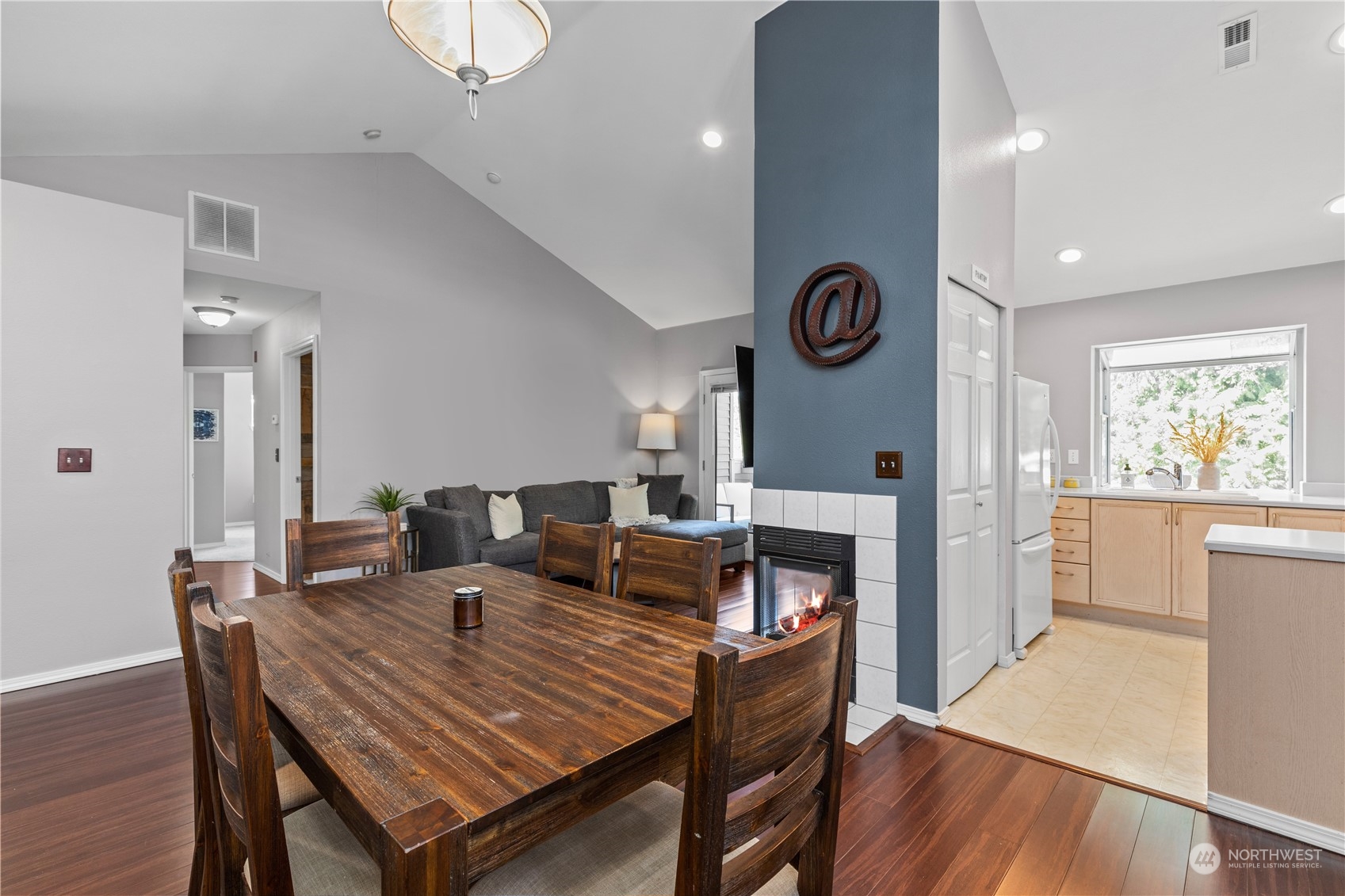 22727 4th Avenue West, Unit 106 Bothell, WA 98021 - Photo 10 of 35 a dining room with furniture a rug a fireplace and wooden floor
