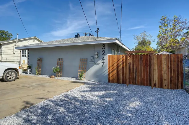 a view of a house with a garage and furniture