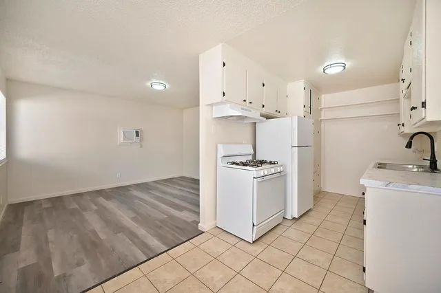 a kitchen with a sink cabinets and appliances